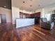 Open floor plan featuring a modern kitchen with stainless steel appliances flowing into the living area with hardwood floors at 155 S Court Ave # 2904-Penthouse, Orlando, FL 32801