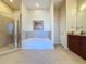 The bathroom features a soaking tub, walk-in shower, and a vanity with granite countertop at 155 S Court Ave # 2904-Penthouse, Orlando, FL 32801