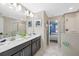 Bathroom with double sinks, dark cabinets, and a large mirror at 1585 Plunker, Davenport, FL 33896