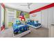 Themed bedroom with 'Toy Story' decor, playful accents, and two twin beds at 1585 Plunker, Davenport, FL 33896