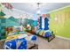 Fun themed Harry Potter bedroom with two twin beds, a bright green wall, and a decorative mural at 1585 Plunker, Davenport, FL 33896