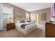 Inviting bedroom with soft lighting, a plush bed, and warm neutral tones at 1585 Plunker, Davenport, FL 33896