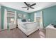 Inviting bedroom with bright teal walls, large windows, and a cozy bed with soft pillows at 1585 Plunker, Davenport, FL 33896