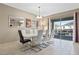 Elegant dining room featuring a large table, modern chandelier, and access to an outdoor pool at 1585 Plunker, Davenport, FL 33896