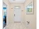 Bright foyer with white tile flooring and a clean, modern aesthetic at 1585 Plunker, Davenport, FL 33896