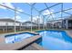 A gorgeous pool and spa with a screened enclosure and backyard view at 1585 Plunker, Davenport, FL 33896