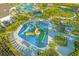 Aerial view of a colorful community splash pad with slides, offering a fun water play area for children at 1585 Plunker, Davenport, FL 33896