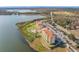 Stunning aerial view of lakeside condos featuring a pool, parking, and beautiful landscaping at 16300 County Road 455 # 712, Montverde, FL 34756