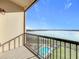 Balcony overlooking a scenic lake with a community pool and lounge area at 16300 County Road 455 # 712, Montverde, FL 34756