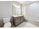 Bathroom showcasing a modern vanity, well-lit mirror, and a bathtub/shower combo, maximizing the use of space at 16300 County Road 455 # 712, Montverde, FL 34756