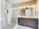 Modern bathroom featuring a glass-enclosed shower and double vanity sinks at 16300 County Road 455 # 712, Montverde, FL 34756