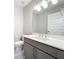 Elegant powder room with gray vanity, quartz countertop, and modern fixtures at 16300 County Road 455 # 712, Montverde, FL 34756