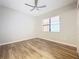 Bedroom with a window, ceiling fan, and beautiful hardwood floors at 16300 County Road 455 # 712, Montverde, FL 34756