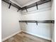 Walk-in closet featuring custom wood shelving and laminate floors at 16300 County Road 455 # 712, Montverde, FL 34756