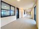 Hallway leading to unit entrance with bright interior and natural light from windows at 16300 County Road 455 # 712, Montverde, FL 34756