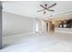 Spacious living room with white marble floors, ceiling fan, and modern kitchen visible in the background at 16300 County Road 455 # 712, Montverde, FL 34756