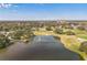 Panoramic view of the golf course community with lake and surrounding neighborhood at 1765 W Schwartz Blvd, Lady Lake, FL 32159