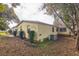 View of backyard showcasing the home's exterior and surrounding landscape at 1765 W Schwartz Blvd, Lady Lake, FL 32159