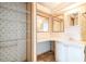 Bathroom vanity with a large corner mirror, and an adjacent linen closet for storage at 1765 W Schwartz Blvd, Lady Lake, FL 32159