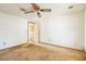 This is a bedroom with off-white walls, carpet flooring and a ceiling fan at 1765 W Schwartz Blvd, Lady Lake, FL 32159