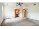 Bedroom with carpet flooring, a ceiling fan and access to an ensuite bathroom at 1765 W Schwartz Blvd, Lady Lake, FL 32159