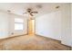 A bedroom with white walls, a ceiling fan and door to a walk-in closet at 1765 W Schwartz Blvd, Lady Lake, FL 32159