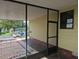View of the carport area showing a screen wall and large windows at 1765 W Schwartz Blvd, Lady Lake, FL 32159