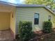 A cozy home exterior featuring neutral siding and verdant landscaping at 1765 W Schwartz Blvd, Lady Lake, FL 32159