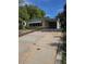 Charming single-story home with a covered carport and an expansive concrete driveway at 1765 W Schwartz Blvd, Lady Lake, FL 32159