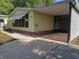 Charming single-story home with a covered carport and an expansive concrete driveway at 1765 W Schwartz Blvd, Lady Lake, FL 32159