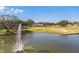 Scenic view of the golf course and a tranquil pond with fountain at 1765 W Schwartz Blvd, Lady Lake, FL 32159