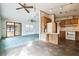 View of the kitchen and living room, featuring tile flooring and wooden cabinets at 1765 W Schwartz Blvd, Lady Lake, FL 32159