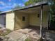 View of a rear patio with an awning, and small windows under a bright blue sky at 1765 W Schwartz Blvd, Lady Lake, FL 32159