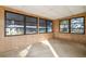 View of the sunroom with multiple windows and wood paneling at 1765 W Schwartz Blvd, Lady Lake, FL 32159