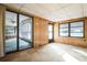 View of the sunroom featuring wood paneling and access to a covered room at 1765 W Schwartz Blvd, Lady Lake, FL 32159