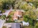 Aerial view of the home featuring a spacious yard, mature trees, and surrounding neighborhood at 1801 Chamberlin St, Orlando, FL 32806