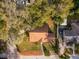 An aerial view showing the home's roof, surrounding mature trees, and driveway at 1801 Chamberlin St, Orlando, FL 32806