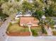 An aerial view showcases the home, its layout, and surrounding landscaping in a residential neighborhood at 1801 Chamberlin St, Orlando, FL 32806