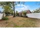 Spacious fenced backyard with mature trees and landscaping at 1801 Chamberlin St, Orlando, FL 32806