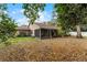 Exterior view of home featuring the screened-in porch and spacious backyard at 1801 Chamberlin St, Orlando, FL 32806