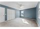 Large bedroom featuring neutral carpeting, a closet with louvered doors, and natural lighting at 1801 Chamberlin St, Orlando, FL 32806