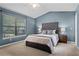 Bedroom with a queen-sized bed, vaulted ceilings, and large window at 1801 Chamberlin St, Orlando, FL 32806