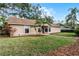 Single-story home featuring a manicured lawn, walkway, and established landscaping at 1801 Chamberlin St, Orlando, FL 32806