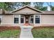 A close up view of the home's entrance and large windows at 1801 Chamberlin St, Orlando, FL 32806