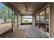 Screened-in porch with ceiling fan, sliding glass doors, and view of the backyard at 1801 Chamberlin St, Orlando, FL 32806