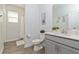 Bright bathroom with tile floors, gray cabinets, modern fixtures, and a shower/tub combination at 1908 Perch Hammock Loop, Groveland, FL 34736