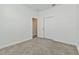 Bright bedroom features neutral carpet and a closet at 1908 Perch Hammock Loop, Groveland, FL 34736