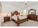 Primary bedroom with a wooden bed frame, carpet, and a window at 1908 Perch Hammock Loop, Groveland, FL 34736