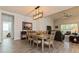 Elegant dining room with modern light fixture and views of the bright living space at 1908 Perch Hammock Loop, Groveland, FL 34736