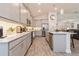 Modern kitchen featuring gray cabinetry, stainless steel appliances, and a center island with a breakfast bar at 1908 Perch Hammock Loop, Groveland, FL 34736